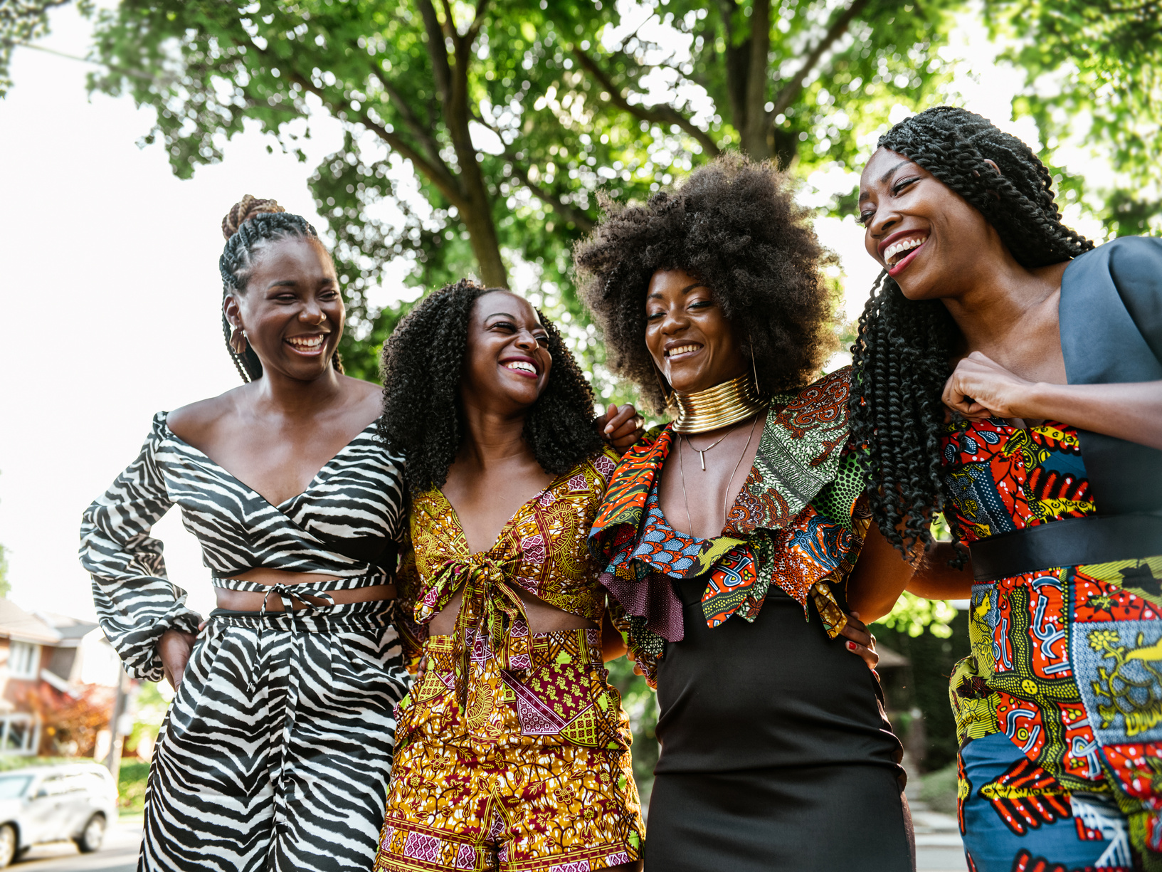 four women in african print dresses