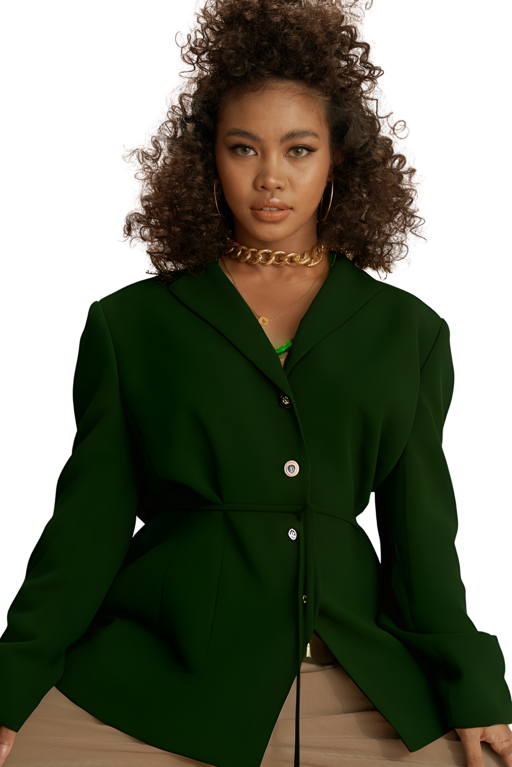 a woman with curly hair wearing a green blazer